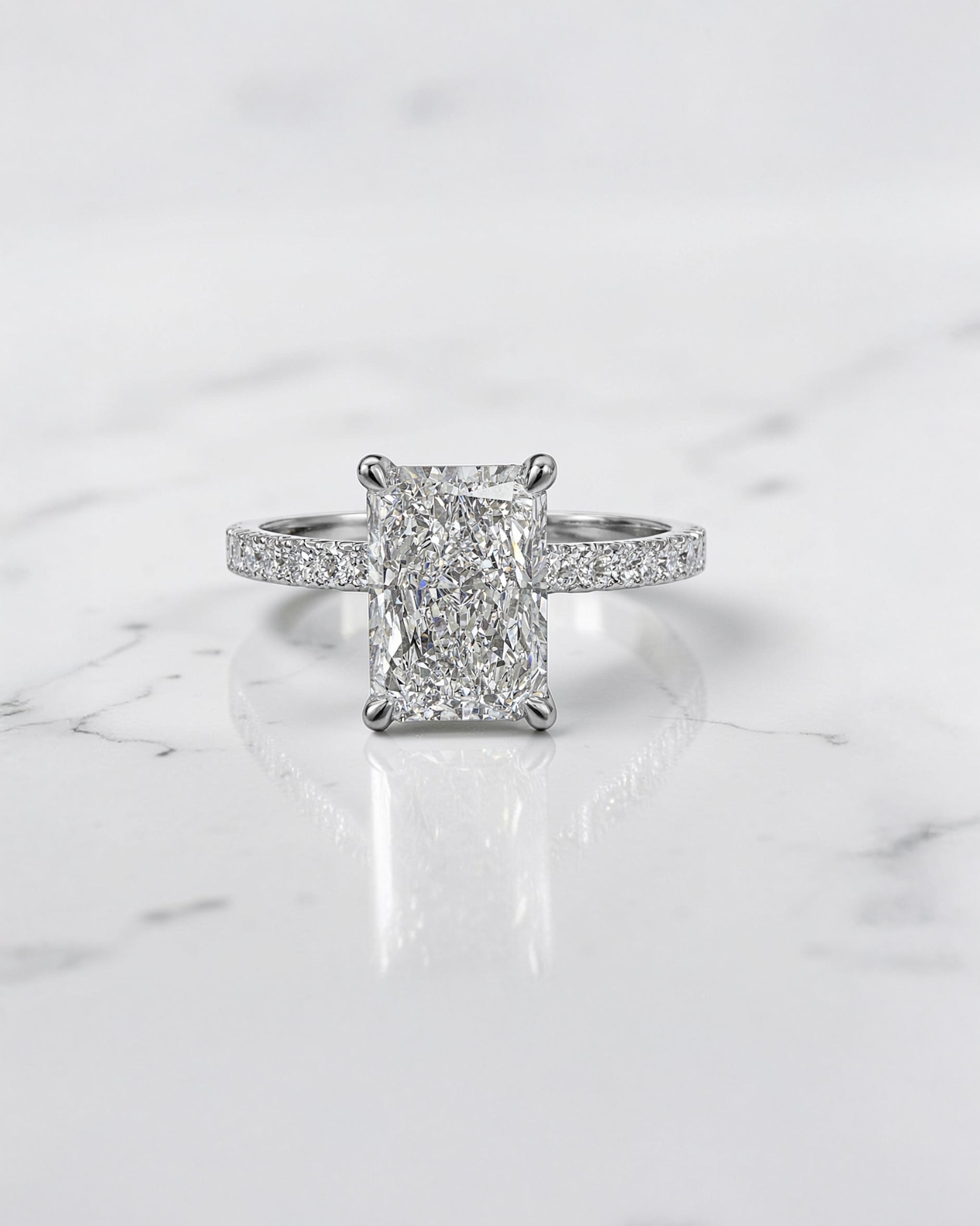 Lab grown 2ct radiant cut diamond engagement ring with hidden halo and pavé diamond shoulders platinum 18kt white gold