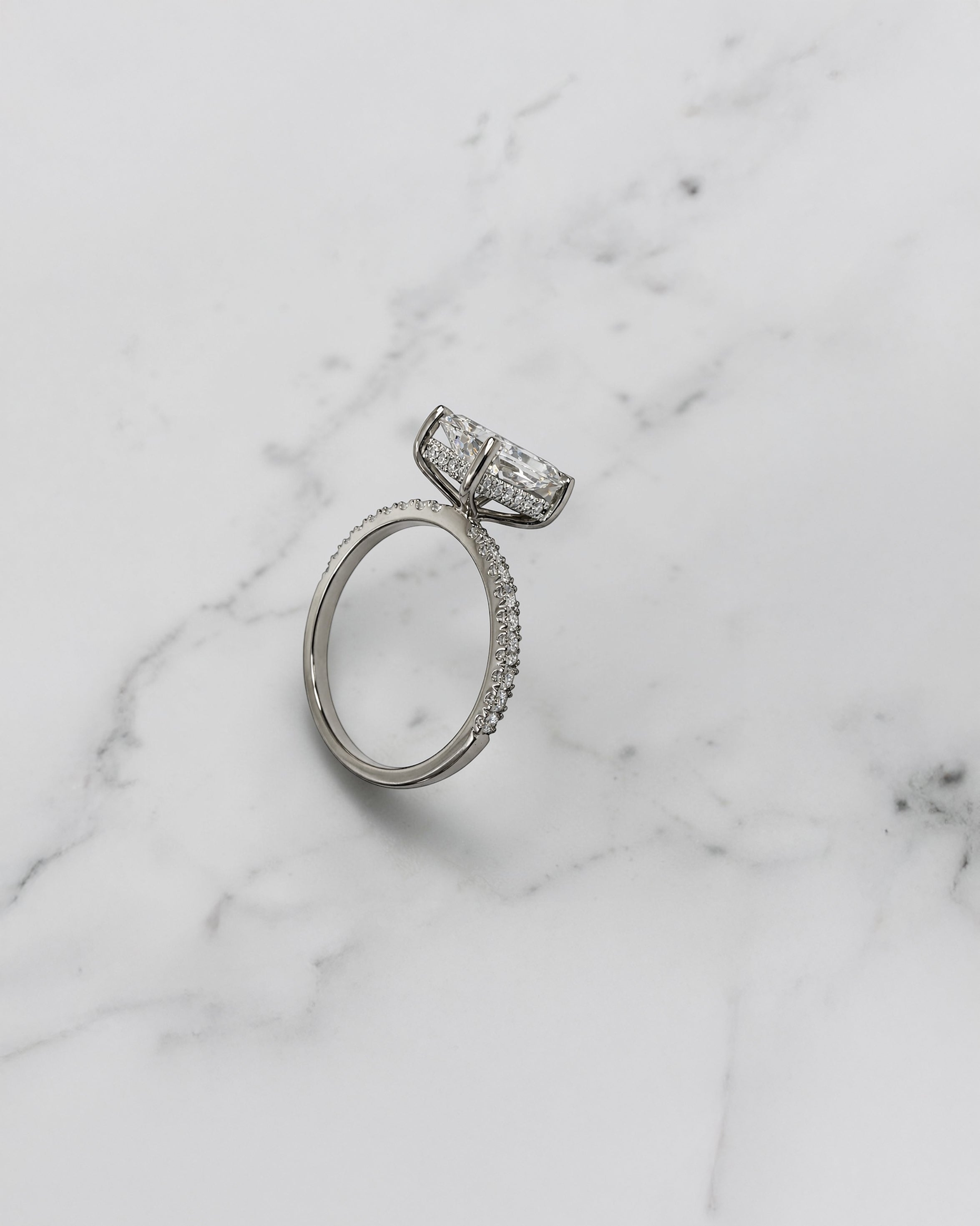 Lab grown 2ct radiant cut diamond engagement ring with hidden halo and pavé diamond shoulders platinum 18kt white gold