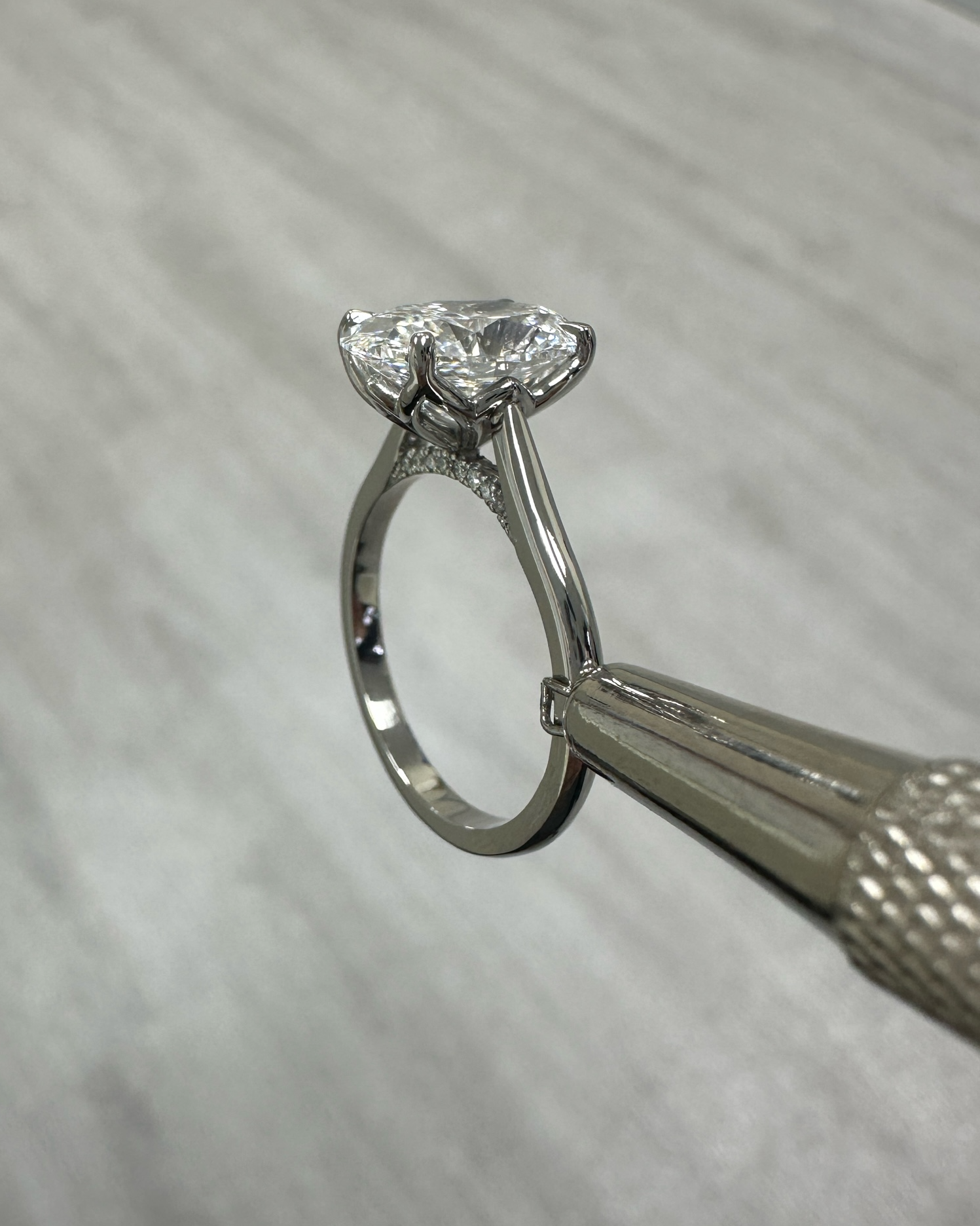 Platinum 3ct oval cut diamond solitaire engagement ring with lotus head and diamond bridge — handcrafted by Layla Diamonds London