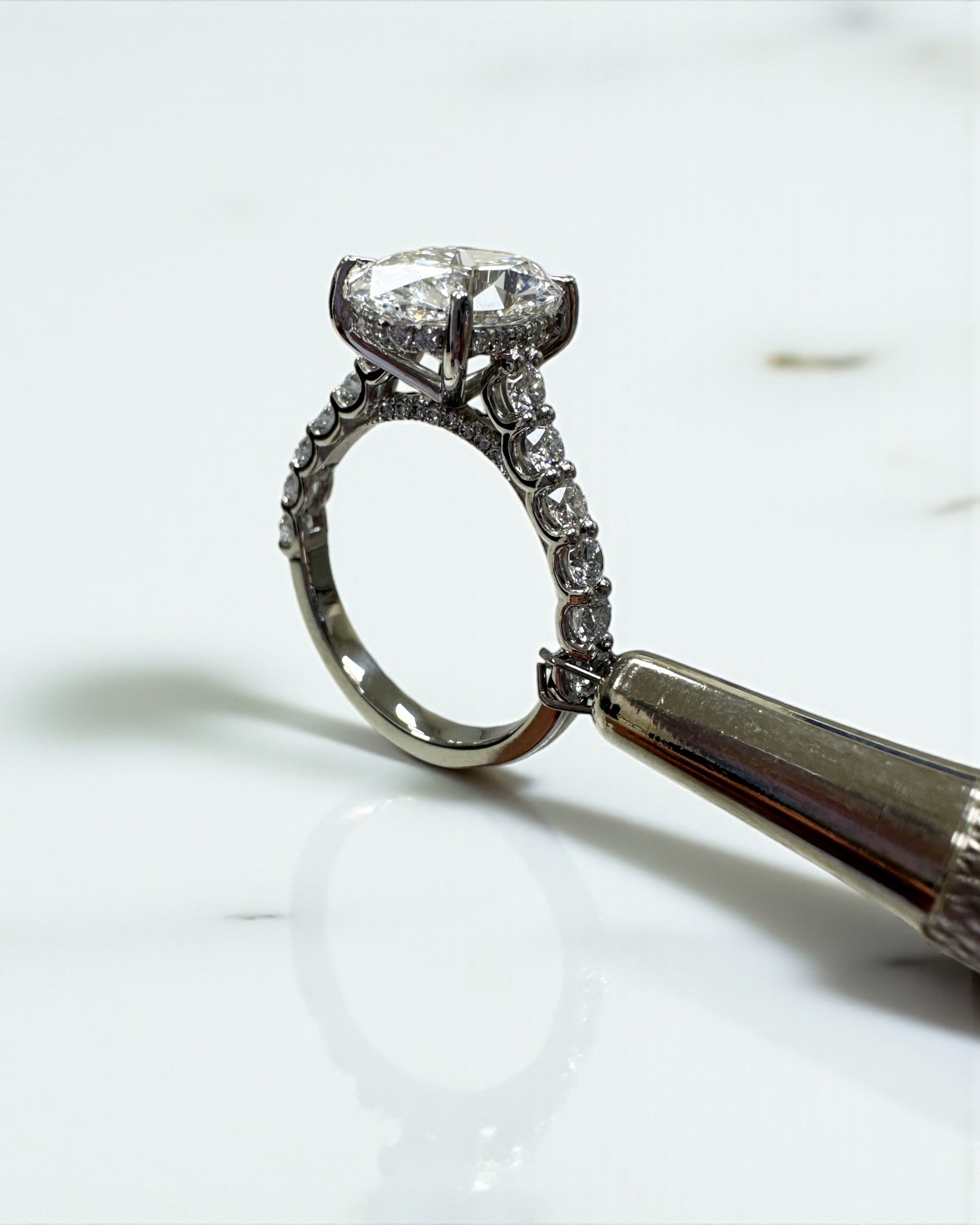 3ct oval cut lab grown diamond u prong setting, cathedral engagement ring in platinum on hand