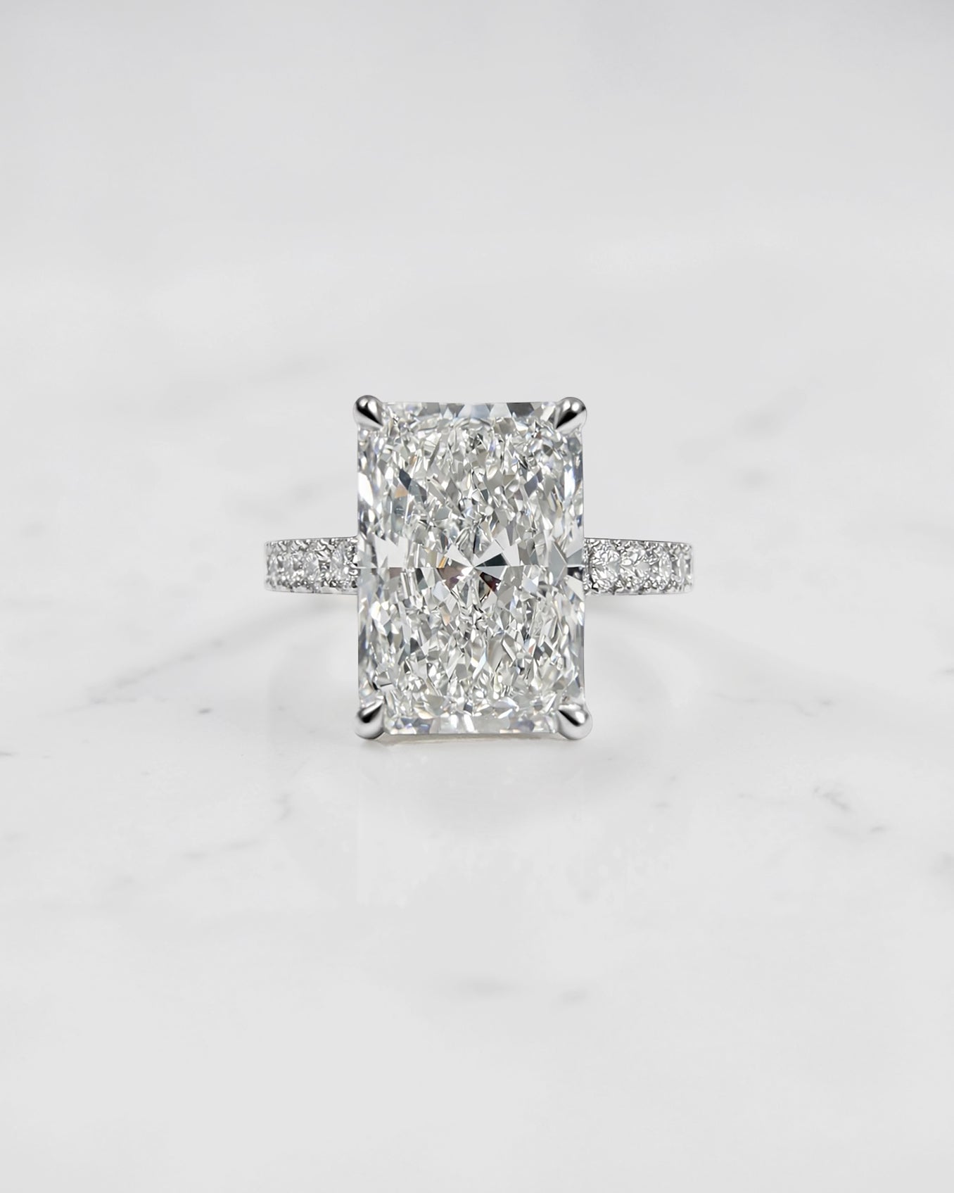 4ct radiant cut lab grown diamond engagement ring with cathedral setting, hidden halo and diamond band. Available in platinum or 18kt yellow or white gold