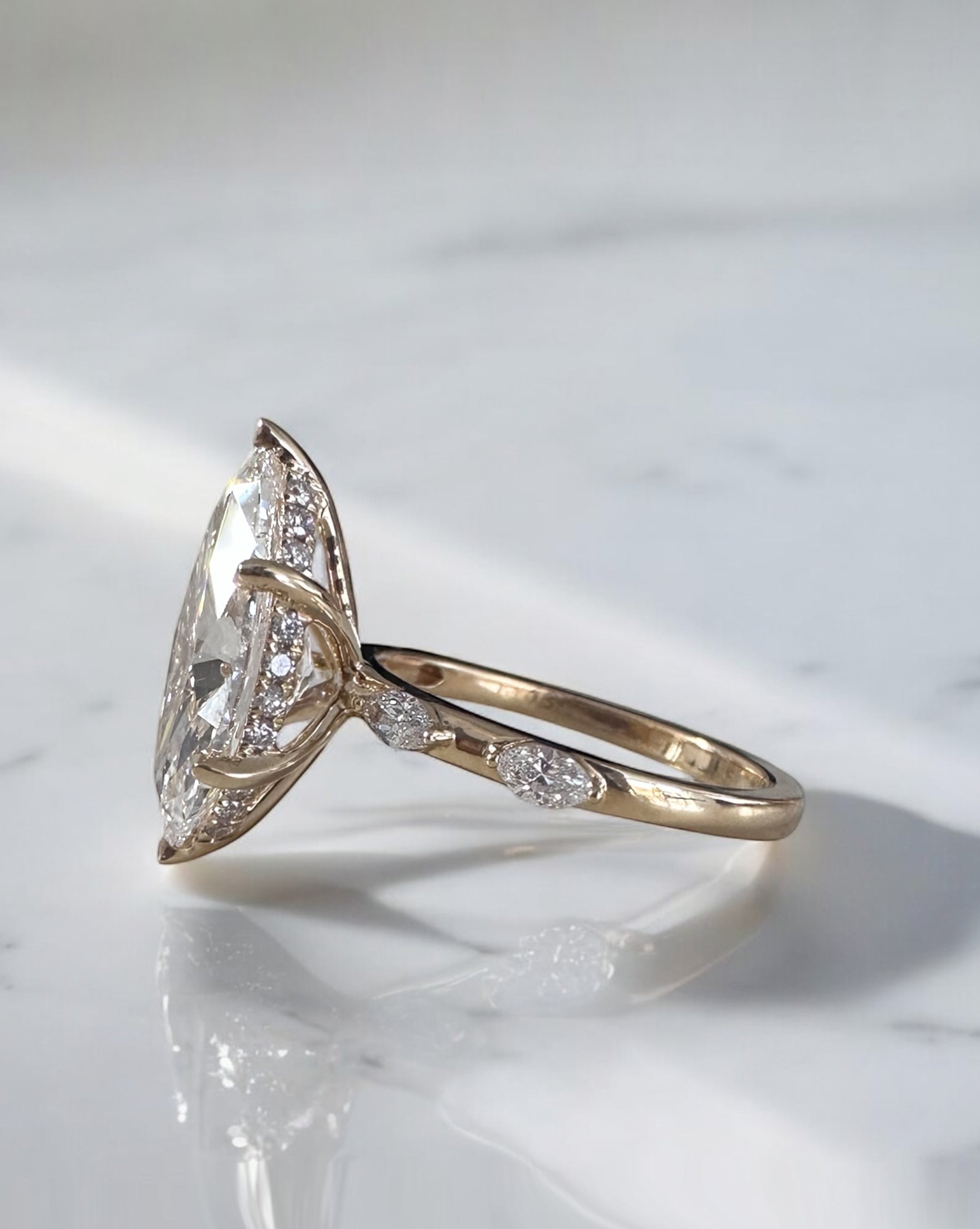 Side view of a 3.50 carat marquise engagement ring showing the setting and band detail.