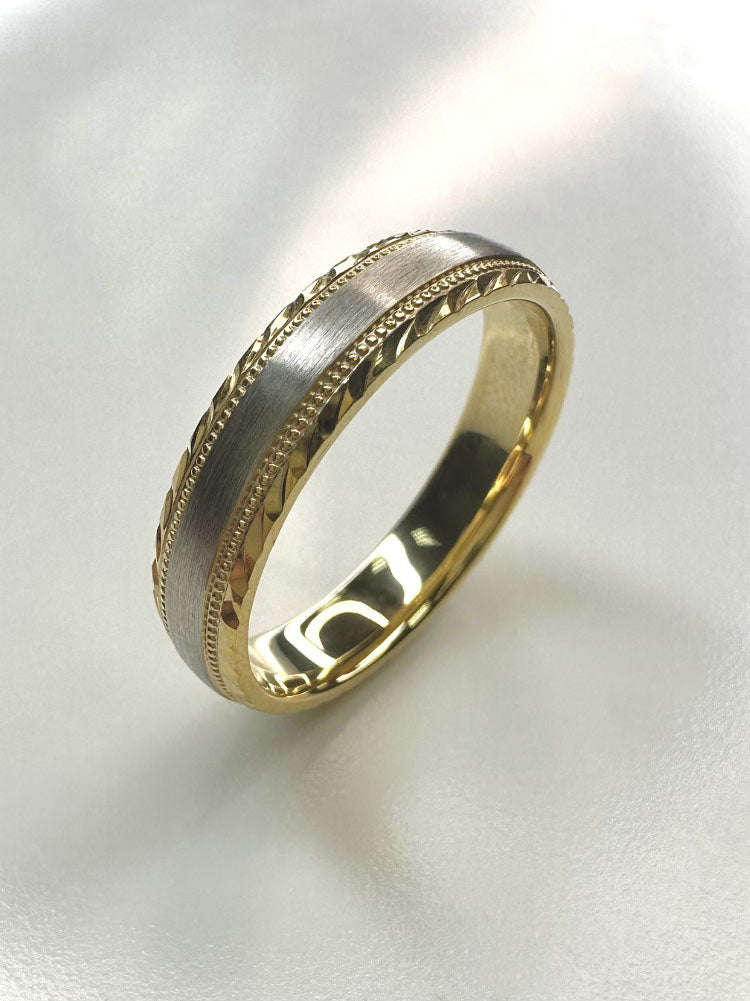 A classic 5mm two-tone milgrain ring with diamond cut edges from our male engagement band collection.