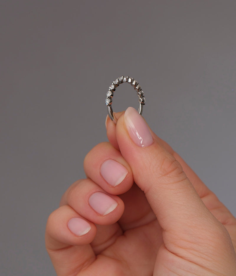 Close-up detail of the round diamonds in this bubble style wedding bands for women.