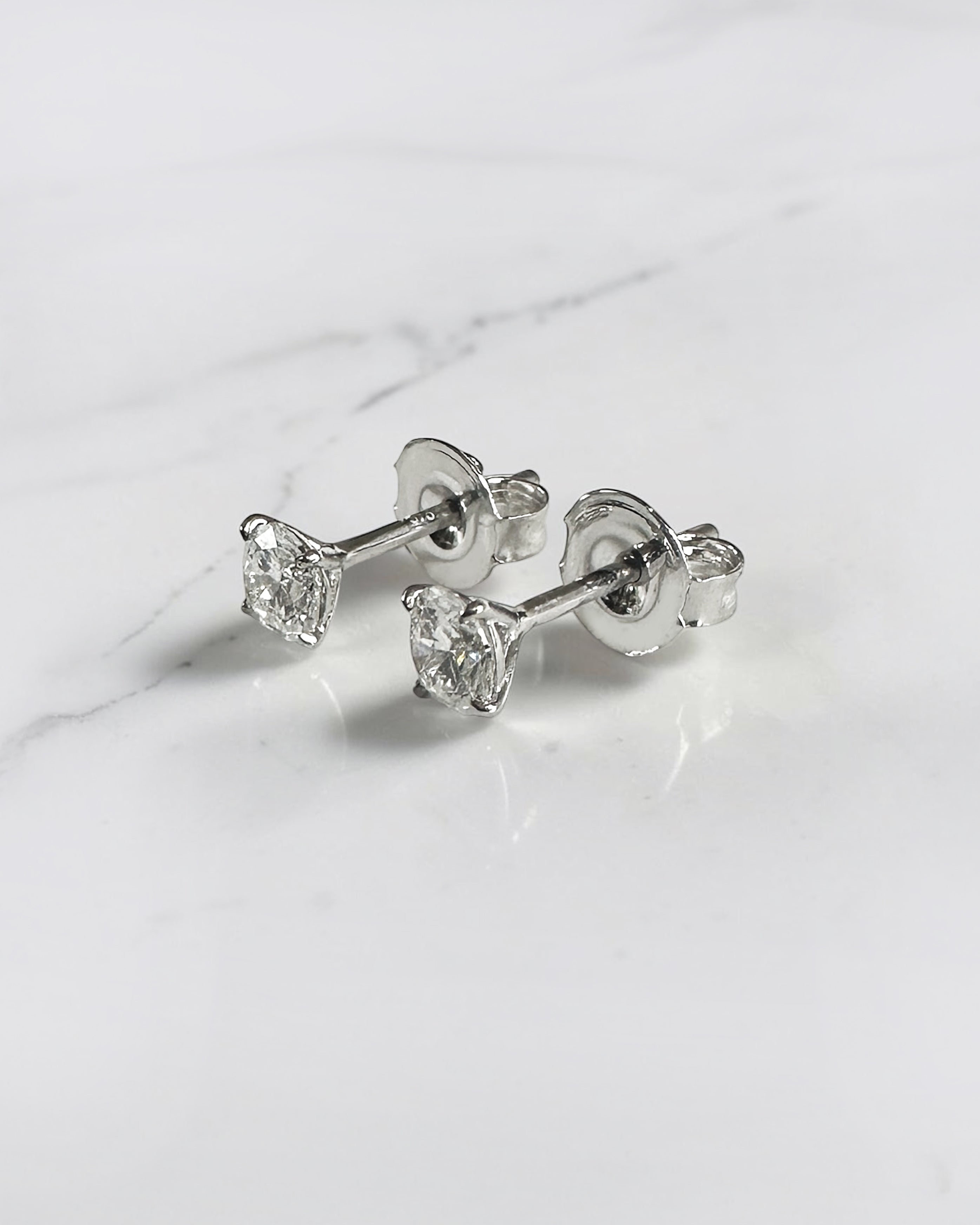 0.50ct round brilliant lab grown diamond martini stud earrings in a four prong setting handcrafted in white gold by Layla Diamonds