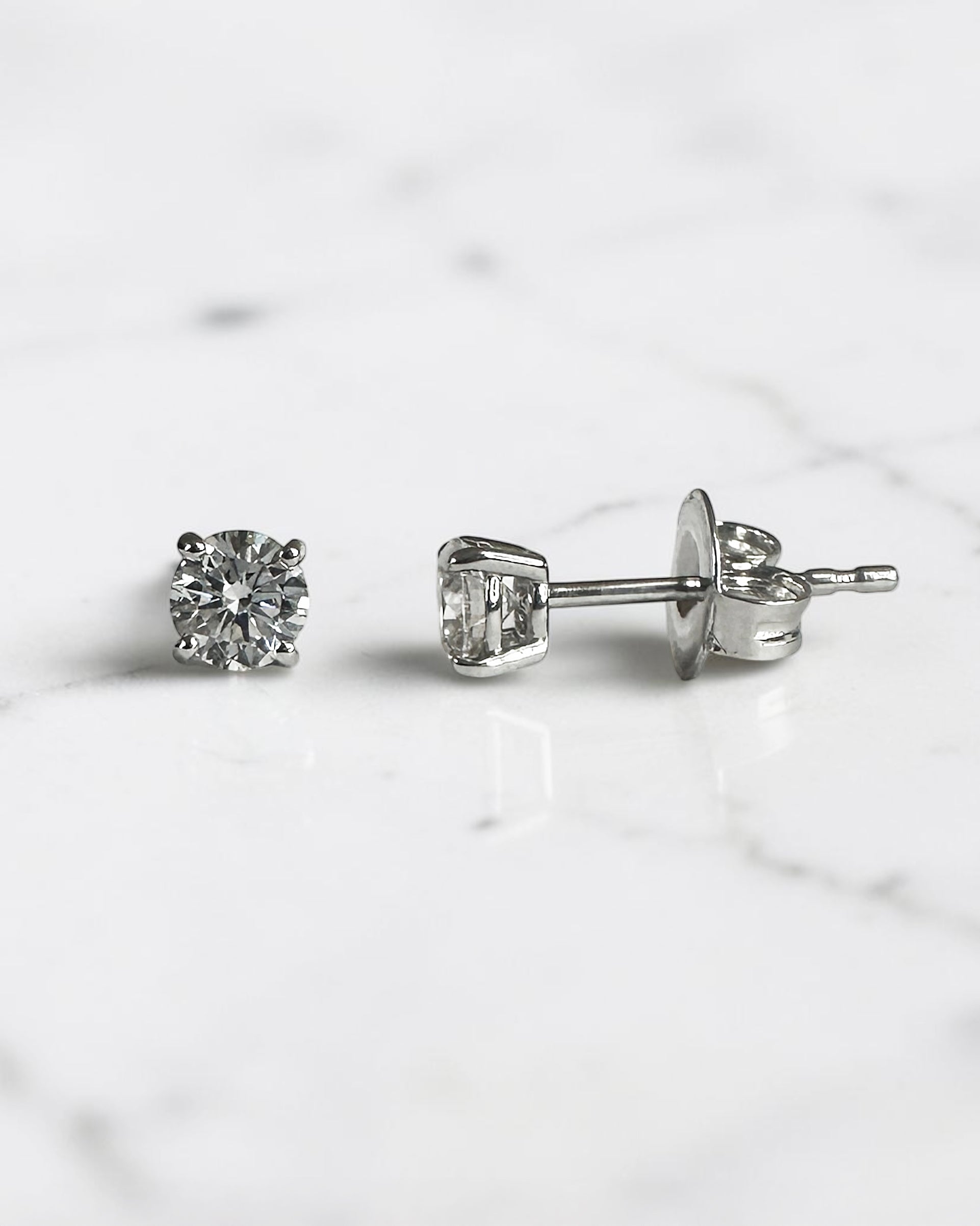 0.50ct round brilliant lab grown diamond stud earrings in a classic four claw setting with minimum E/F colour and VS1 clarity by Layla Diamonds.