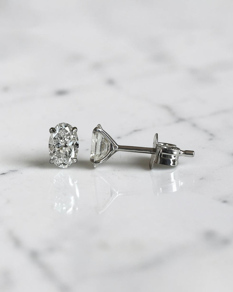 0.70ct oval diamond stud earrings featuring two 0.35ct oval brilliant cut diamonds in a classic four prong setting with secure butterfly backs.