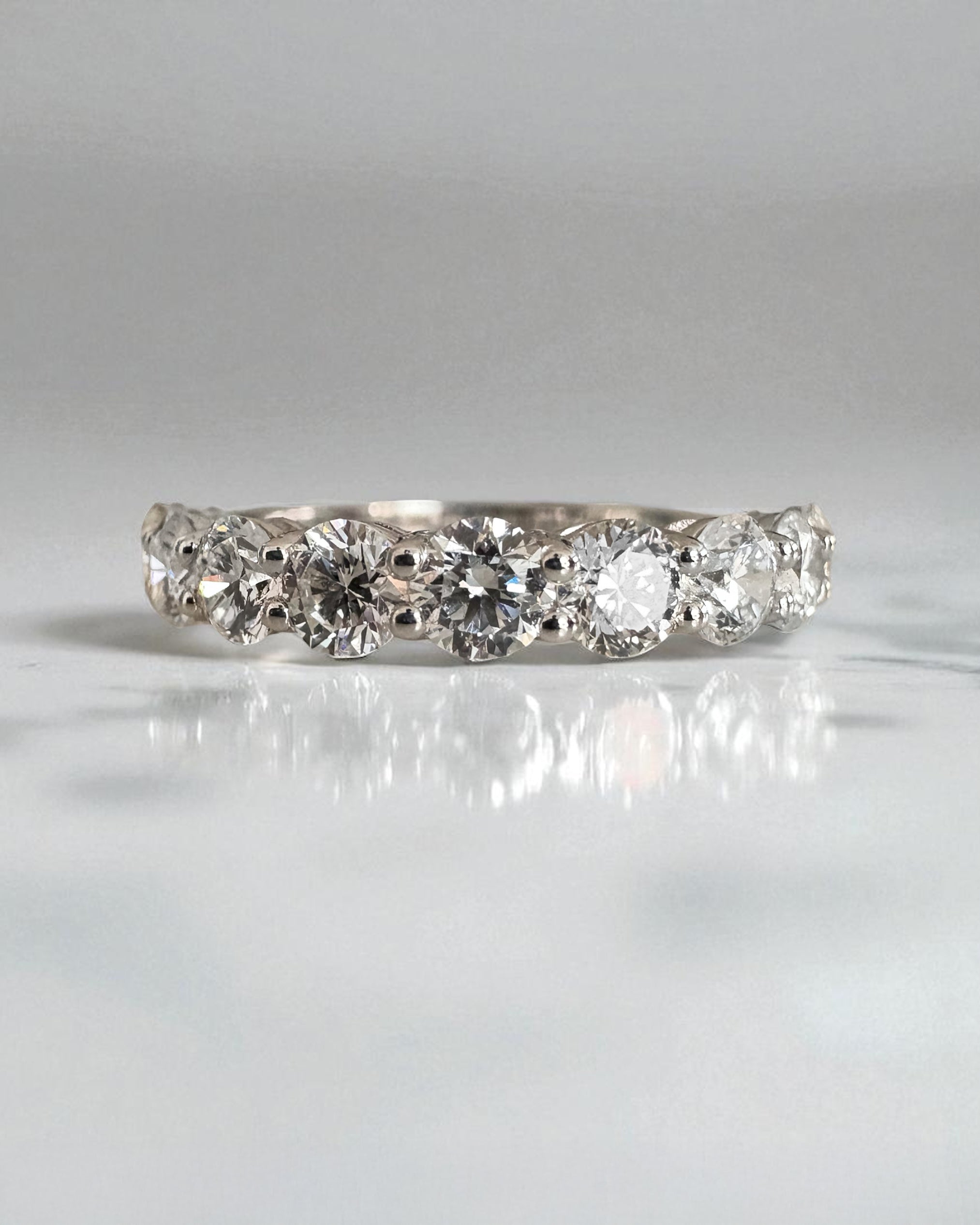 Close-up detail of the high-quality round diamonds on this elegant diamond engagement band.