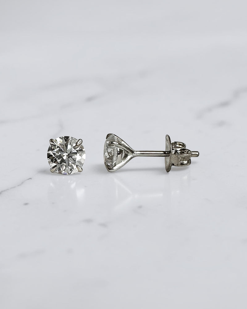 1.20ct round brilliant lab grown diamond stud earrings in a four prong martini setting with E/F colour, VS1+ clarity, available in white gold, yellow gold or platinum.