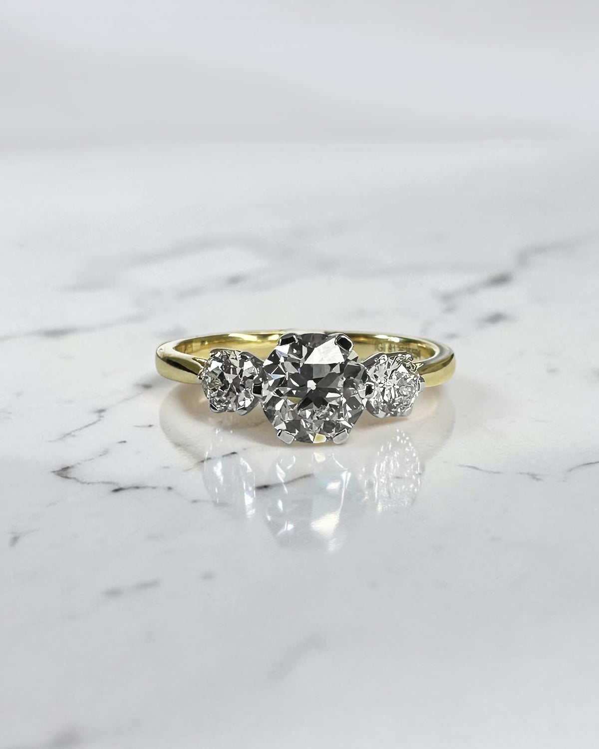 1.40ct Old Mine Cut trilogy diamond engagement ring with 1ct centre diamond, platinum setting and 18ct yellow gold band.