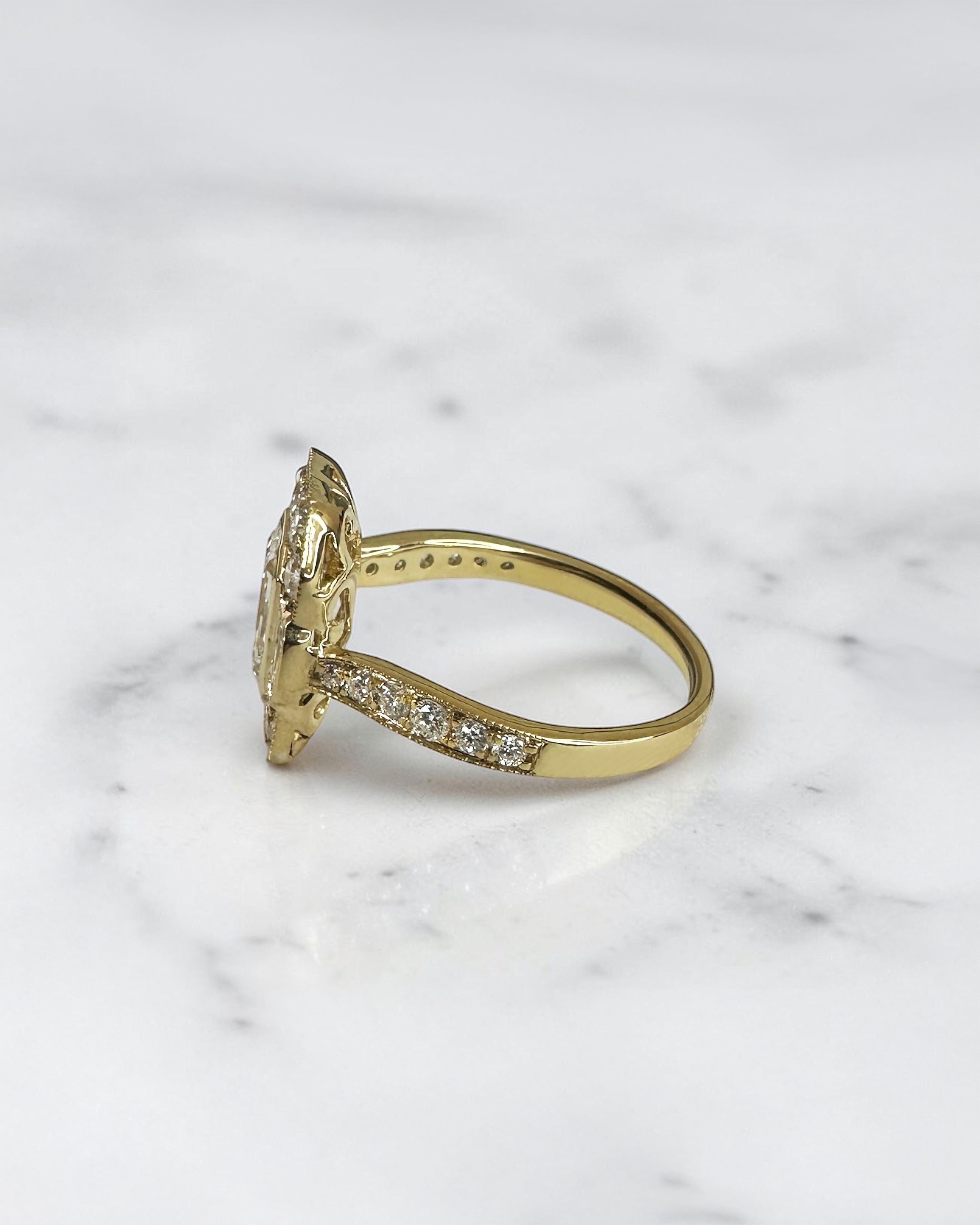 1.50ct emerald cut lab grown diamond vintage halo engagement ring with emerald cut side stones, diamond shoulders and 2.60ct total diamonds
