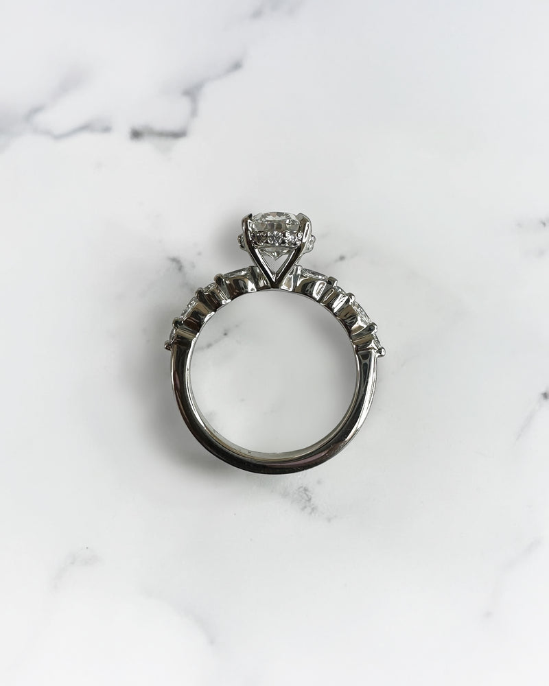 1.50ct oval cut lab grown diamond engagement ring with marquise and round diamond shoulders and hidden halo