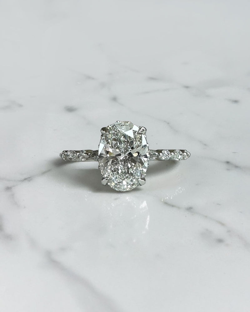 1.50ct oval cut lab grown diamond engagement ring with marquise and round diamond shoulders and hidden halo