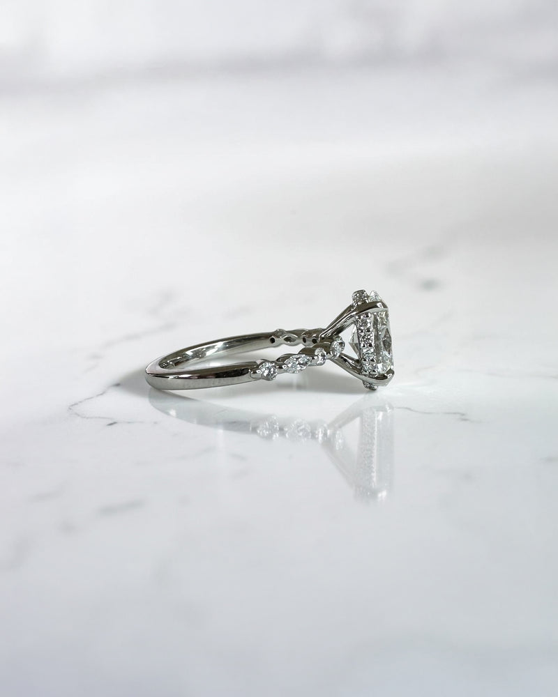 1.50ct oval cut lab grown diamond engagement ring with marquise and round diamond shoulders and hidden halo