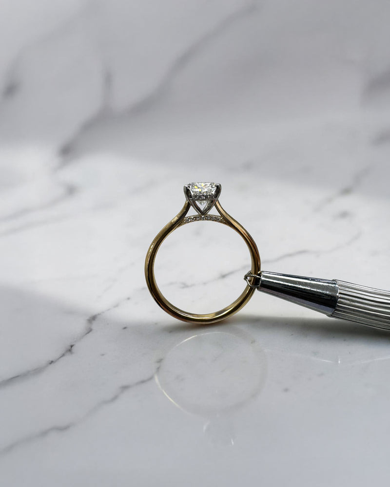 Oval cut diamond solitaire engagement ring 1.50ct, cathedral setting, two tone yellow gold band and platinum head