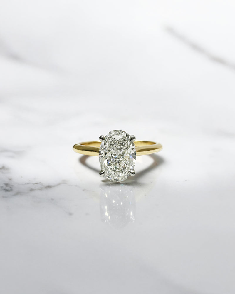 Oval cut diamond cathedral engagement ring 1.50ct, two tone yellow gold band with platinum head, hidden diamond bridge detail