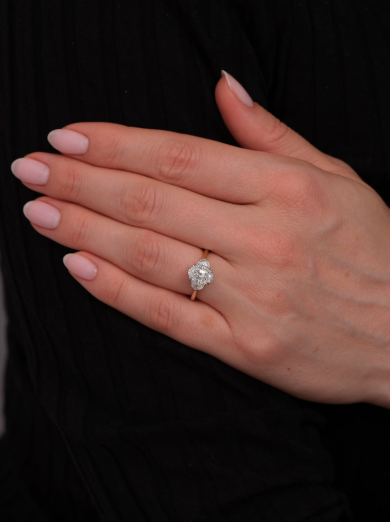 1.50ct oval cut lab grown diamond trilogy engagement ring on hand with half moon side diamonds and platinum head by Layla Diamonds.