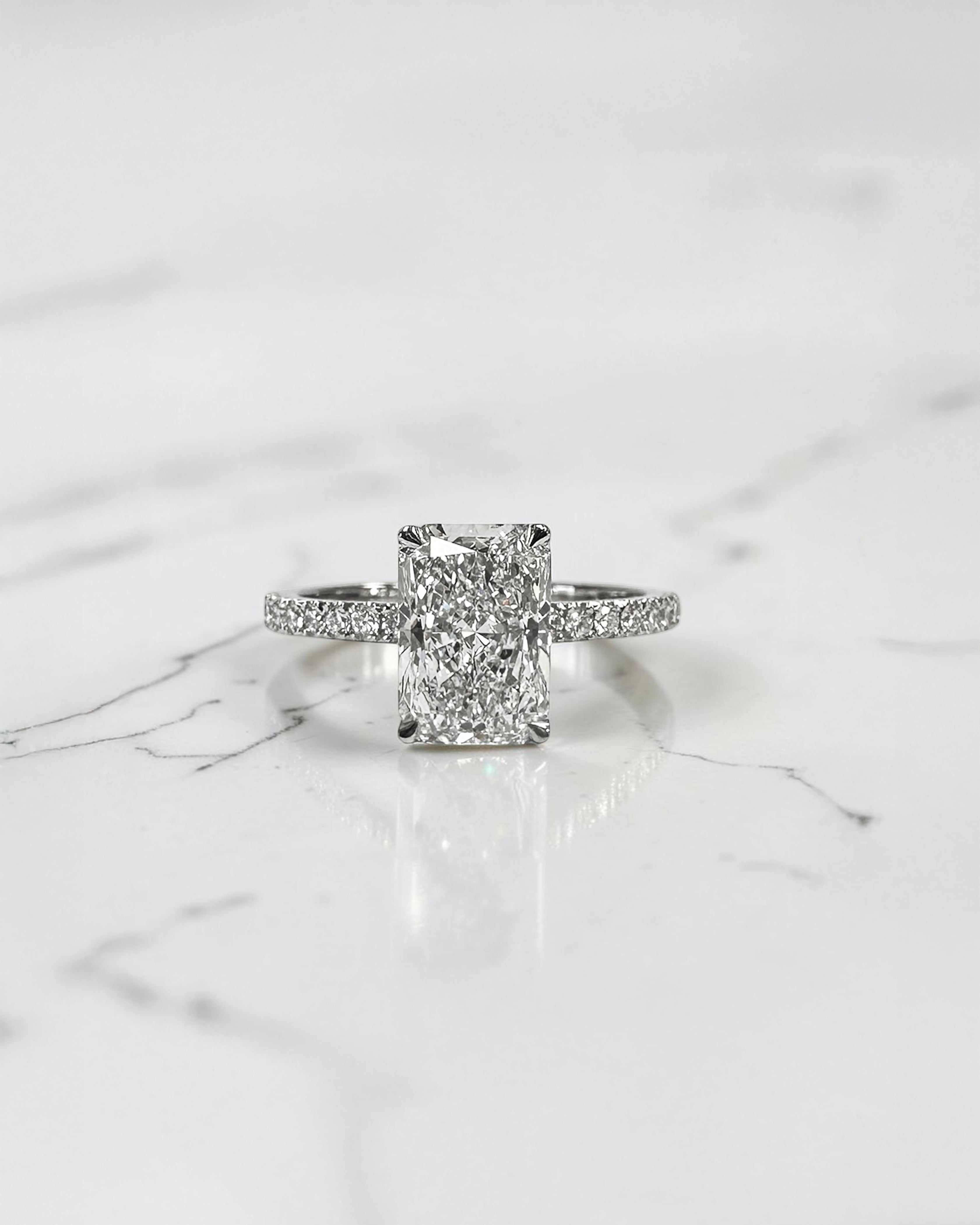 1.80ct radiant cut lab grown diamond engagement ring with diamond shoulder band and wrap around hidden halo in platinum, handmade in London by Layla Diamonds.