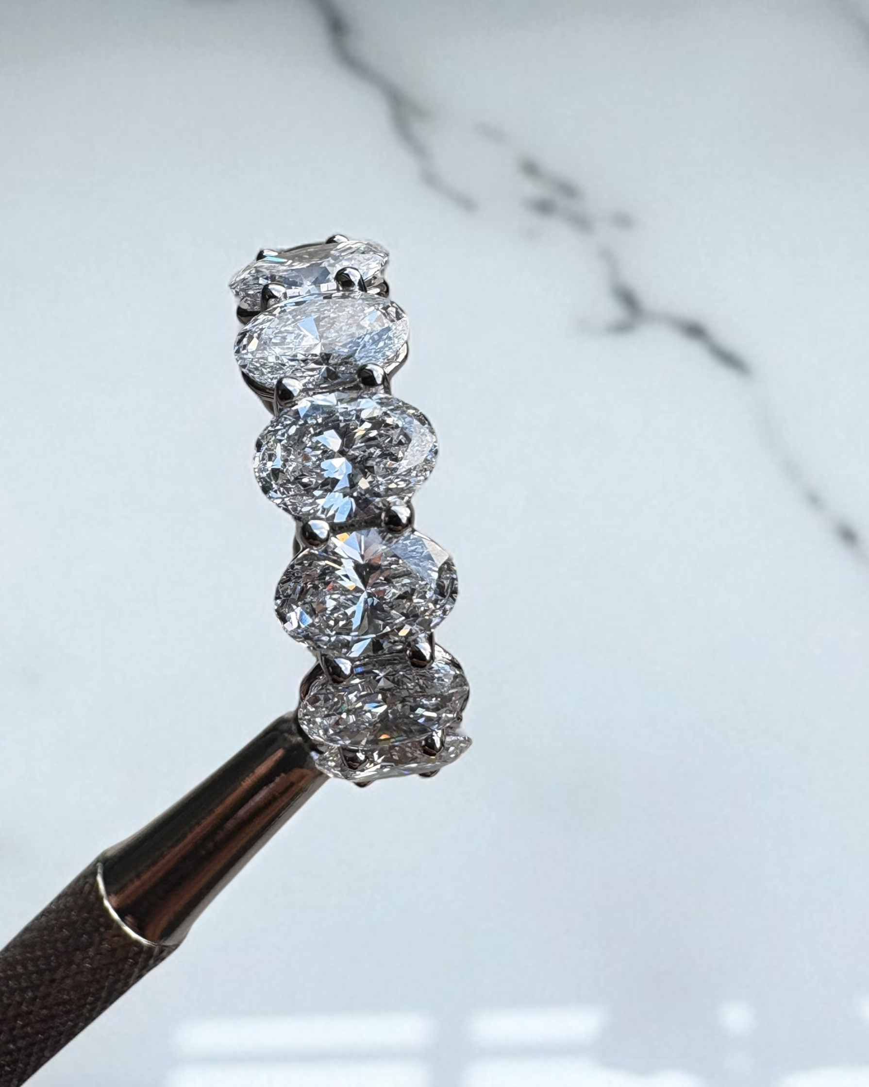 Close-up detail of the high-carat oval cut diamonds on this luxury oval diamond engagement rings style.