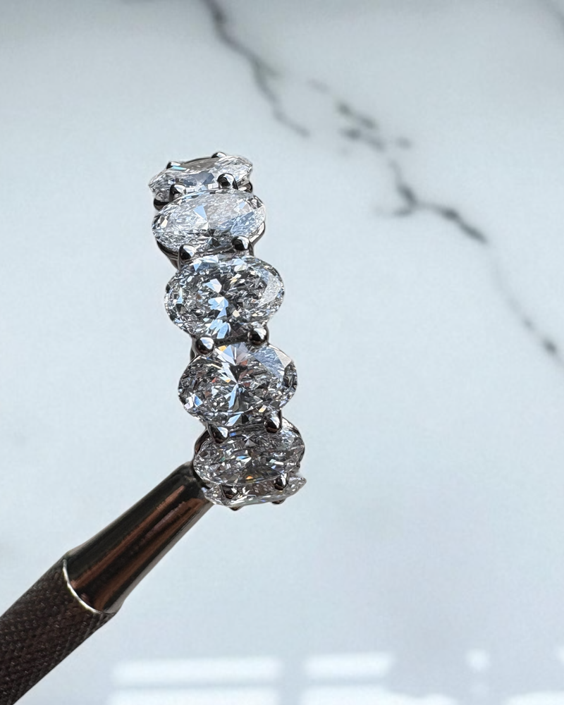 Close-up detail of the high-carat oval cut diamonds on this luxury oval diamond engagement rings style.