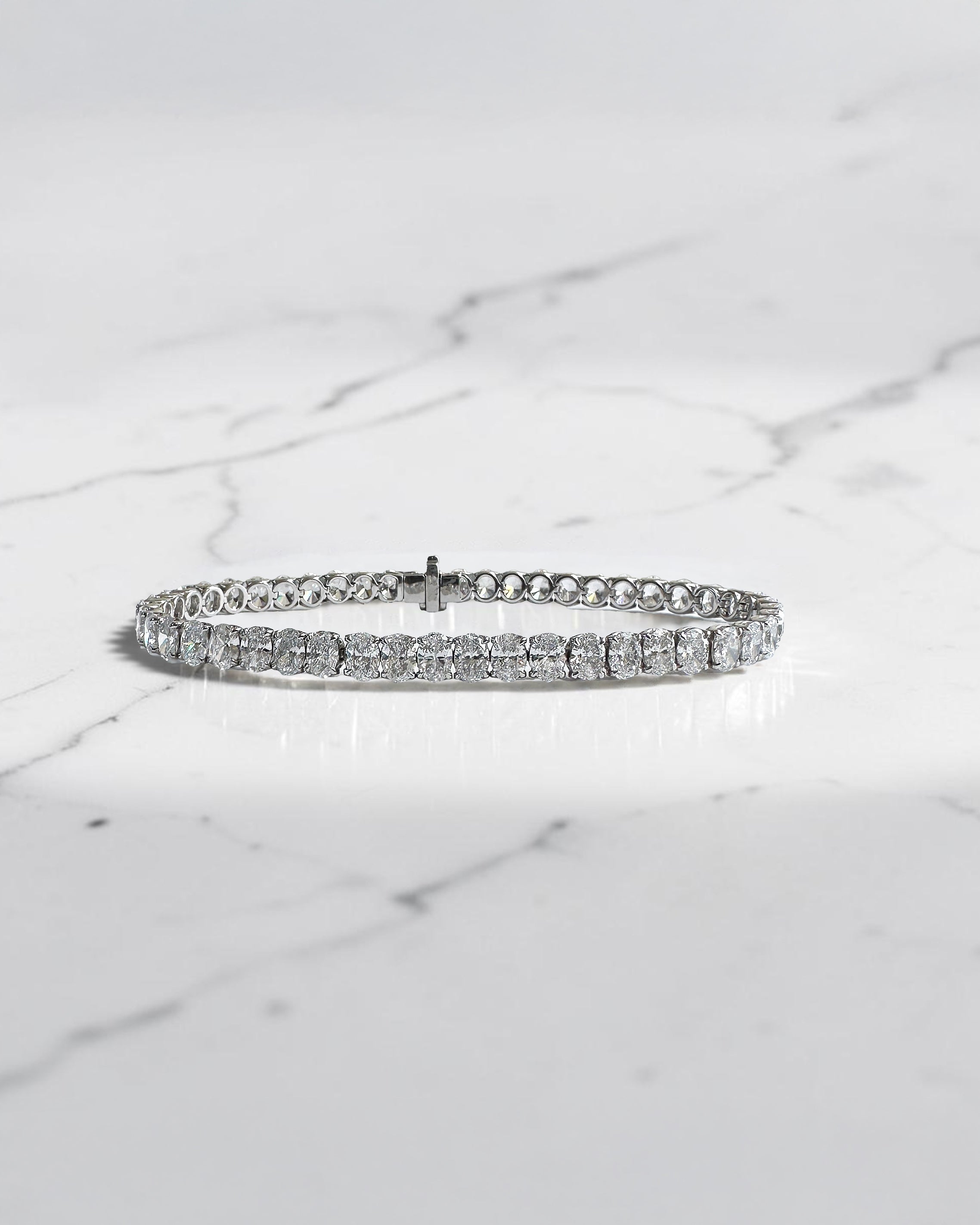 10ct oval cut diamond tennis bracelet in white gold featuring approximately 10 carats of oval diamonds with a 4.80mm width, available in lab grown or natural diamonds.