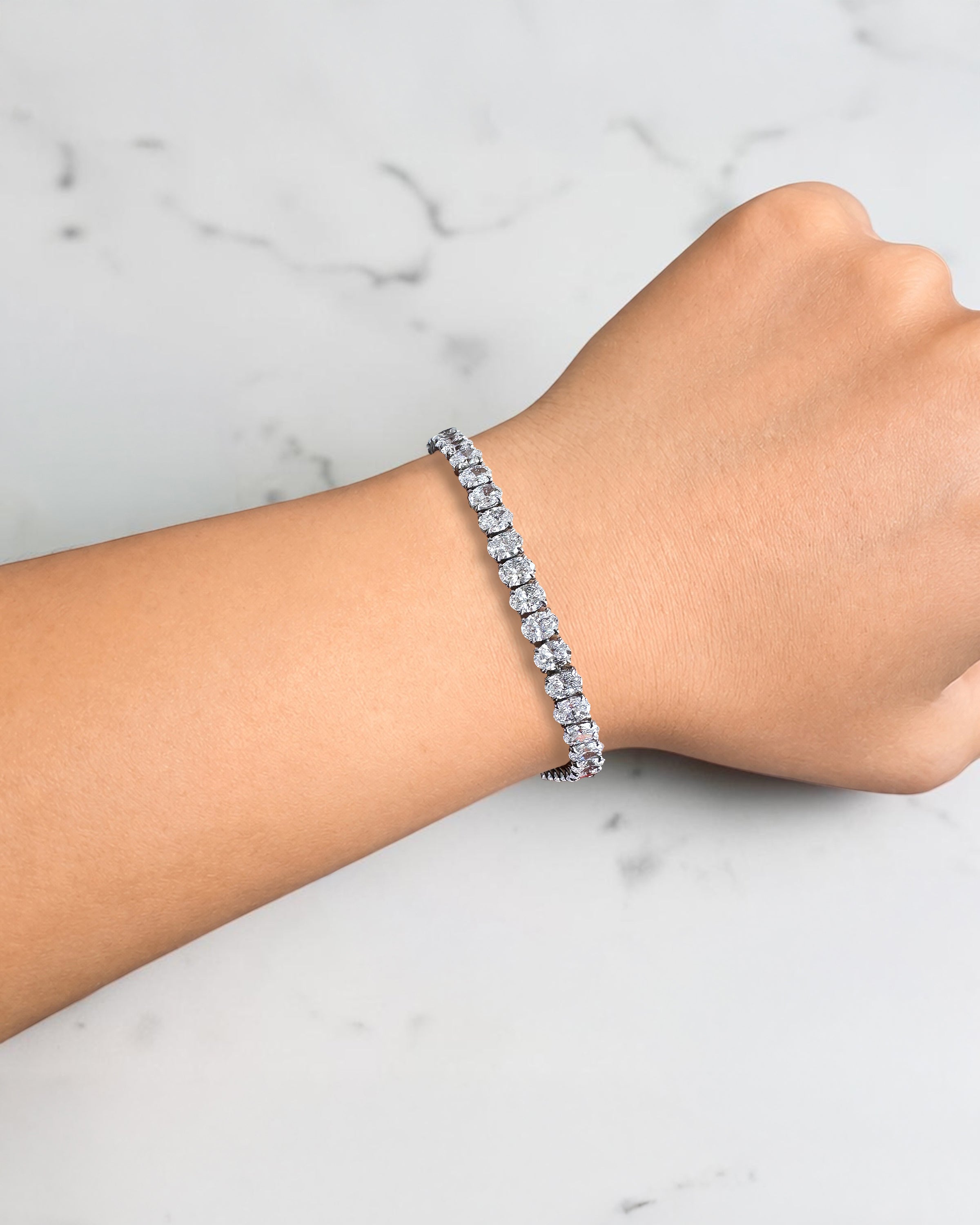 10ct oval cut diamond tennis bracelet in white gold featuring approximately 10 carats of oval diamonds with a 4.80mm width, available in lab grown or natural diamonds.