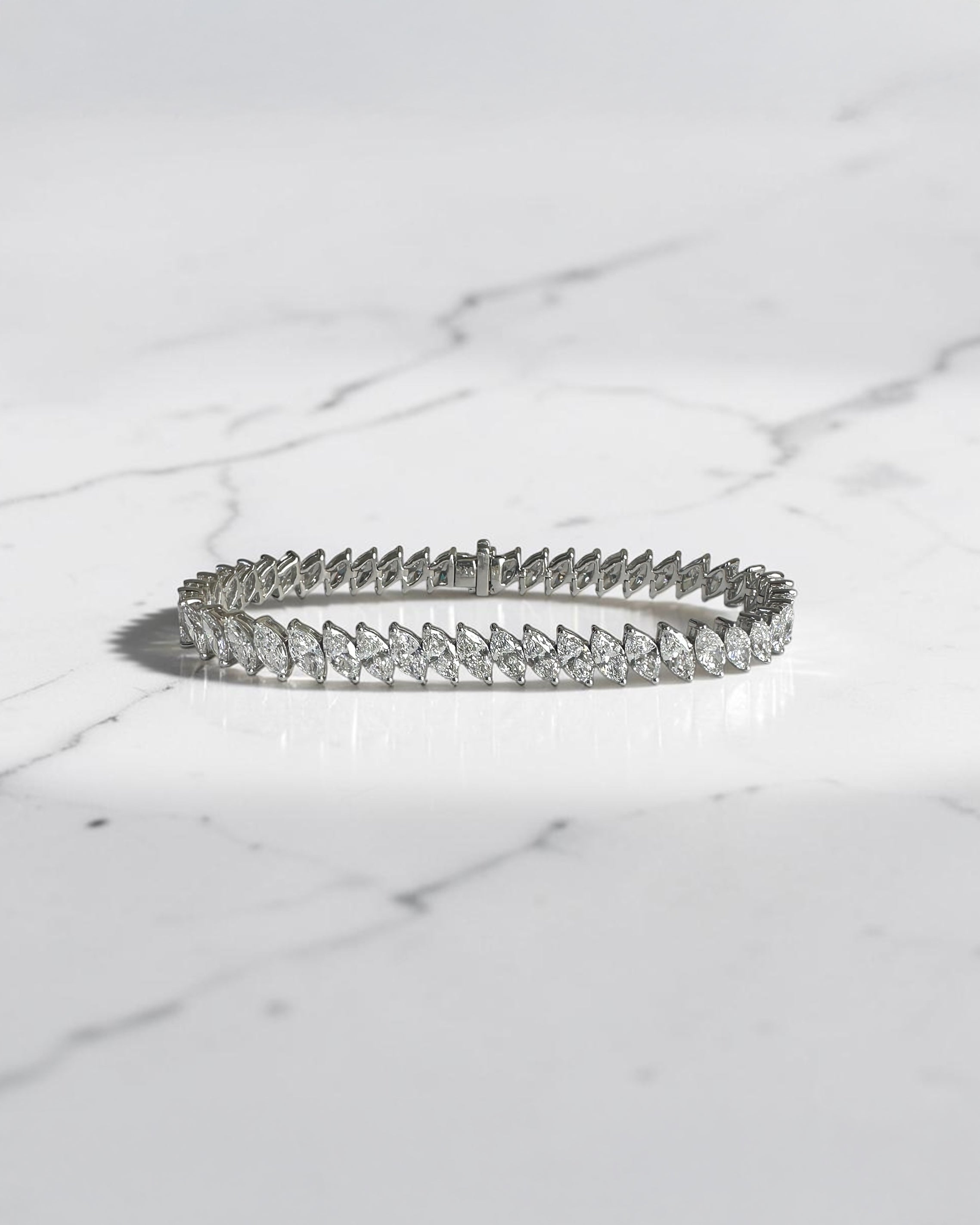 12ct slanted marquise cut diamond tennis bracelet in white gold featuring sparkling marquise diamonds in a modern slanted setting.