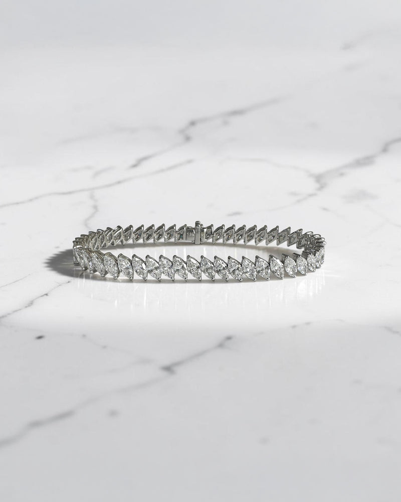 12ct slanted marquise cut diamond tennis bracelet in white gold featuring sparkling marquise diamonds in a modern slanted setting.