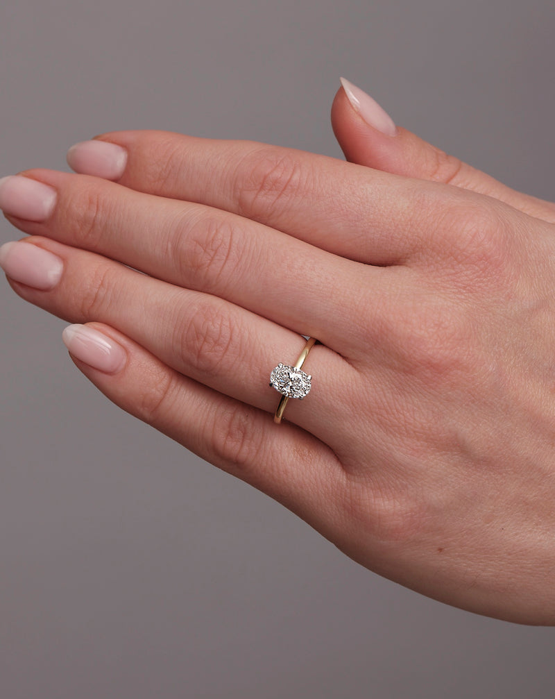 1.25ct oval cut lab grown diamond hidden halo solitaire engagement ring on hand with platinum head by Layla Diamonds