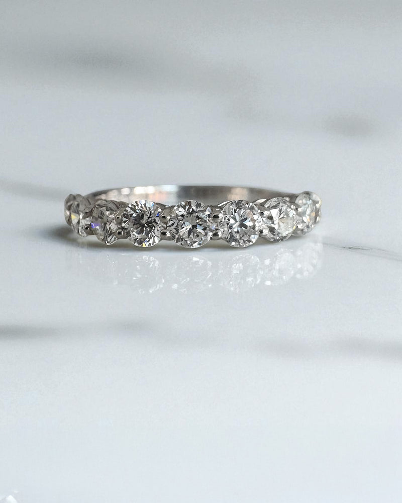 Close-up detail of the brilliant round diamonds on this classic diamond wedding bands style.