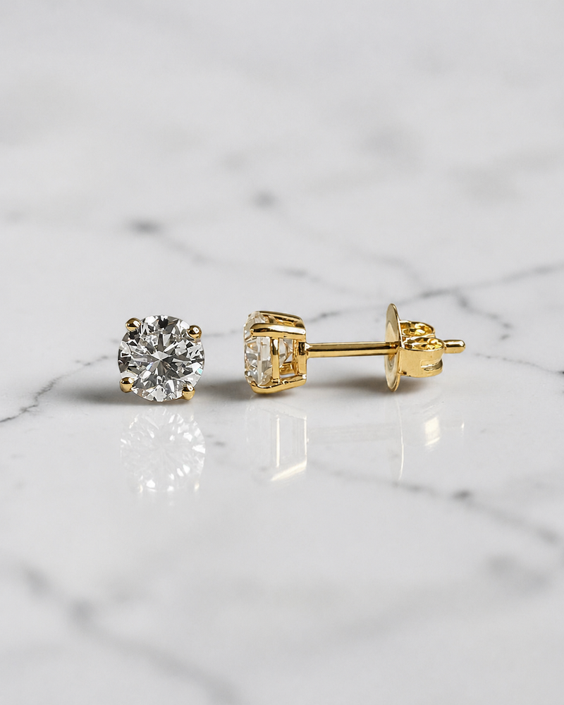 1ct round brilliant lab grown diamond stud earrings with 0.50ct diamonds in a classic four claw basket setting, available in white gold, yellow gold or platinum.