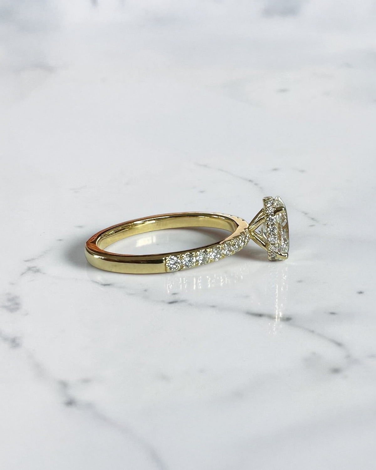 1ct oval cut lab grown diamond engagement ring with wrap around hidden halo and diamond shoulder band