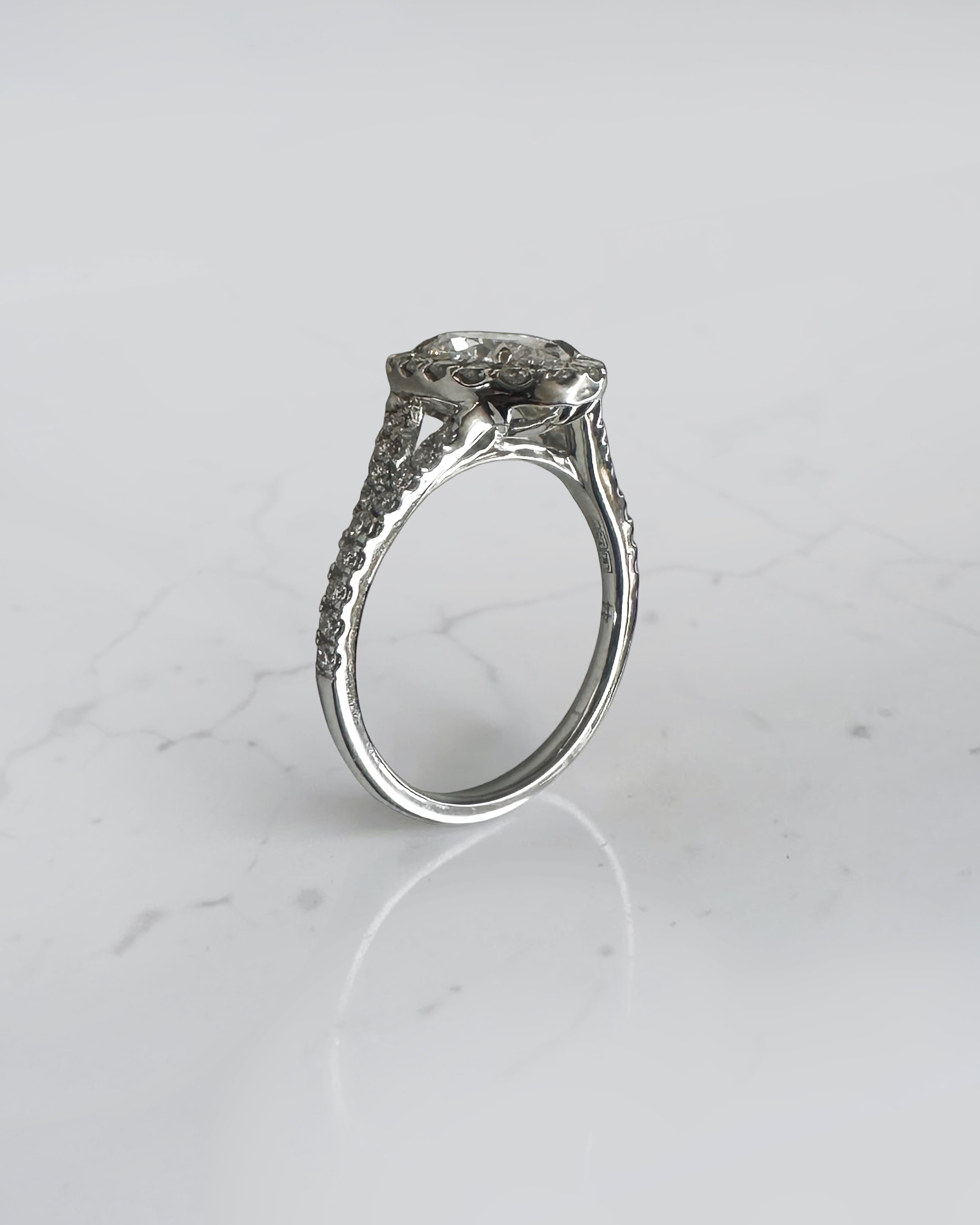 1ct oval cut lab grown diamond halo engagement ring with diamond set split shoulders in white gold
