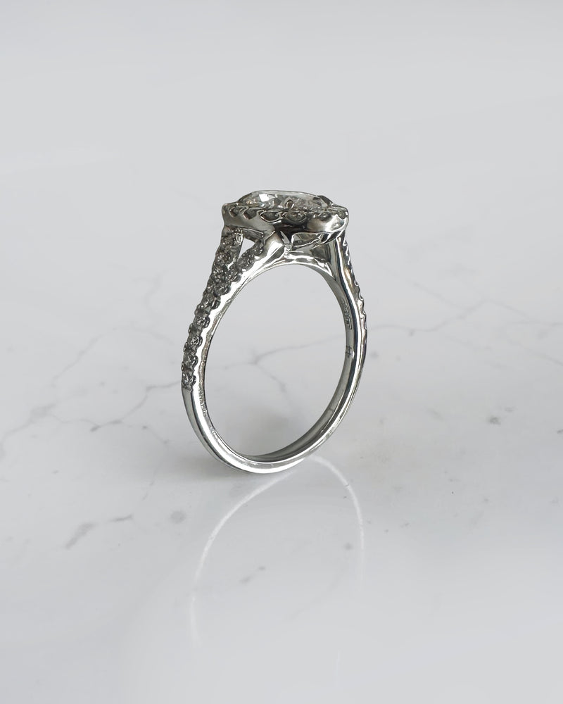 1ct oval cut lab grown diamond halo engagement ring with diamond set split shoulders in white gold
