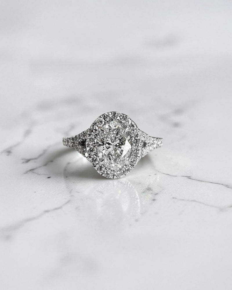 1ct oval cut lab grown diamond halo engagement ring with diamond set split shoulders in white gold
