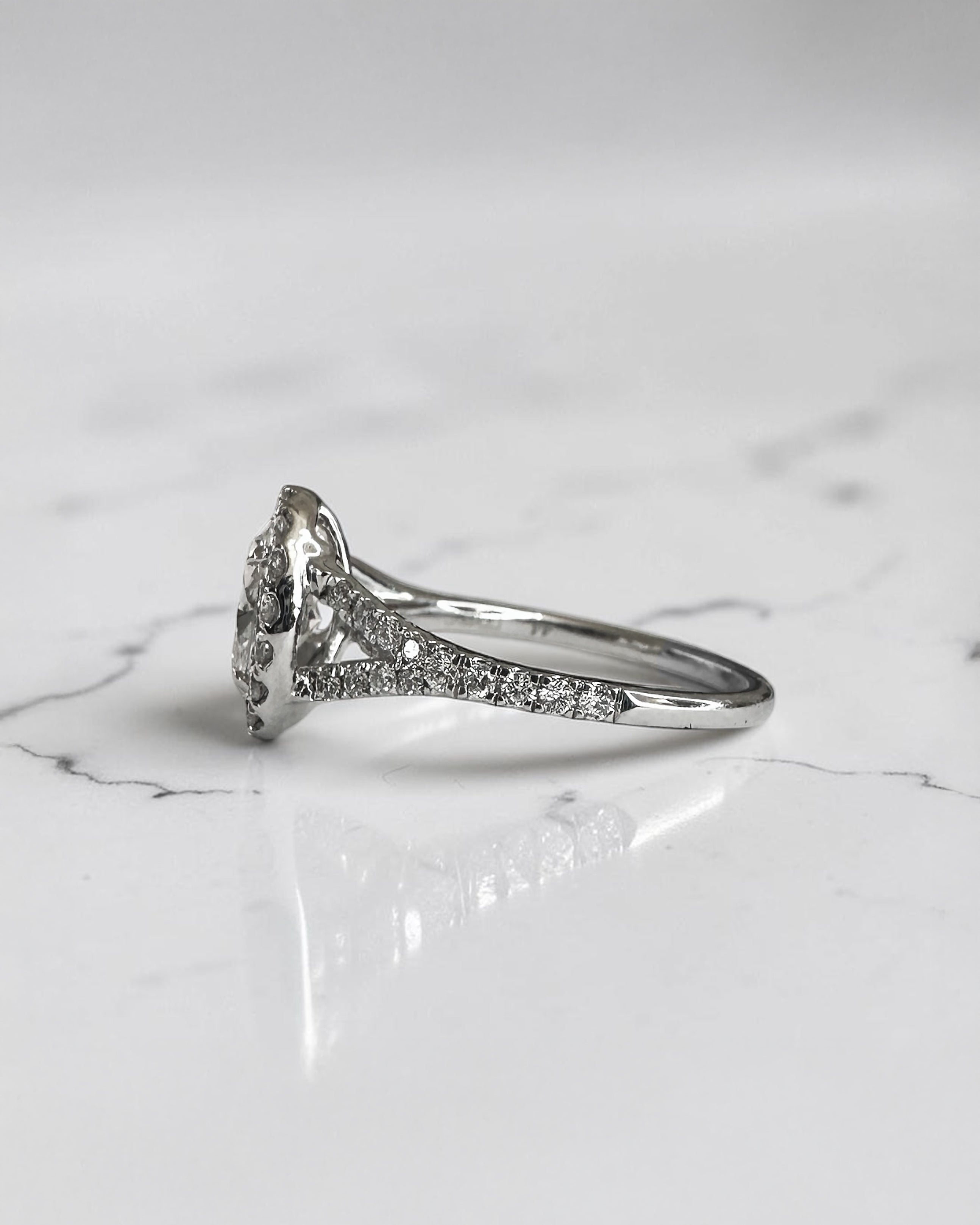 1ct oval cut lab grown diamond halo engagement ring with diamond set split shoulders in white gold
