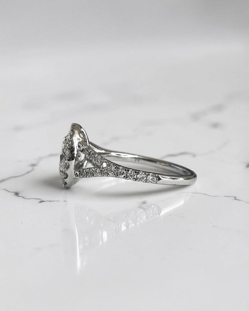 1ct oval cut lab grown diamond halo engagement ring with diamond set split shoulders in white gold
