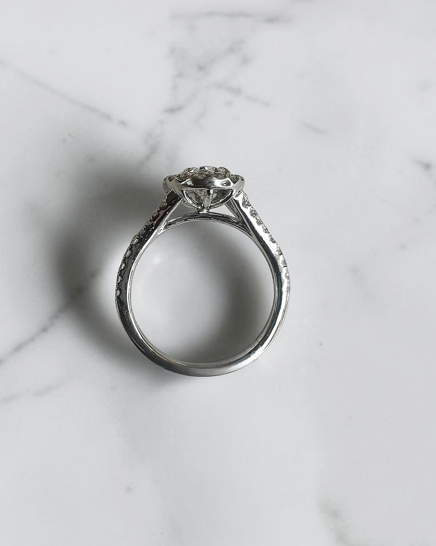 1ct oval cut lab grown diamond halo engagement ring with diamond set split shoulders in white gold

