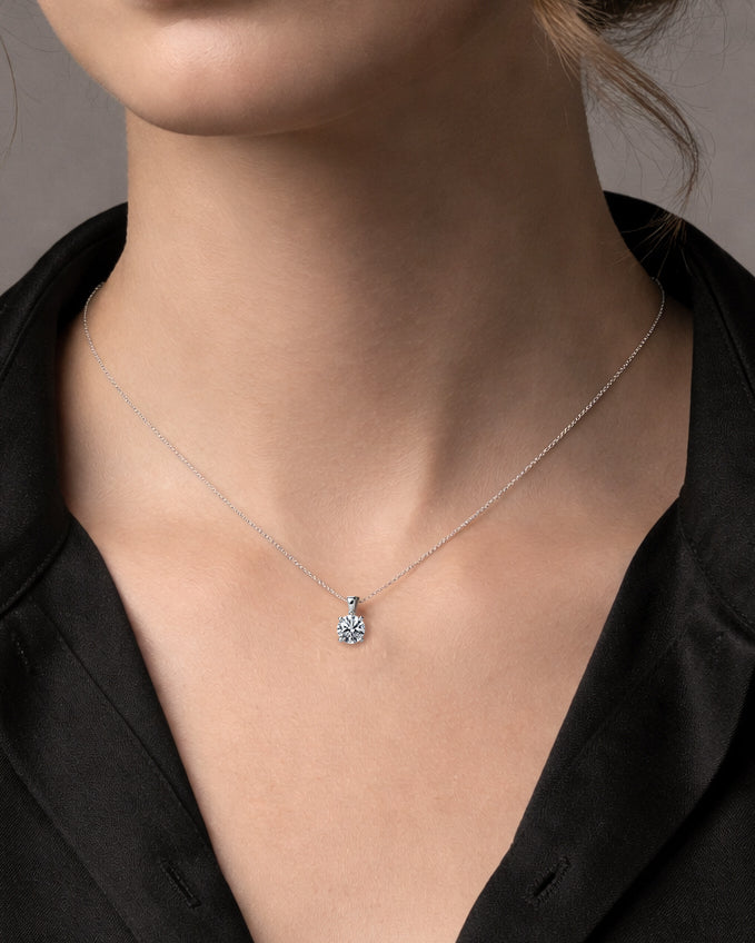 Timeless 1ct round brilliant cut diamond pendant with an adjustable 16–18 inch gold chain. Crafted in 9kt or 18kt yellow or white gold.