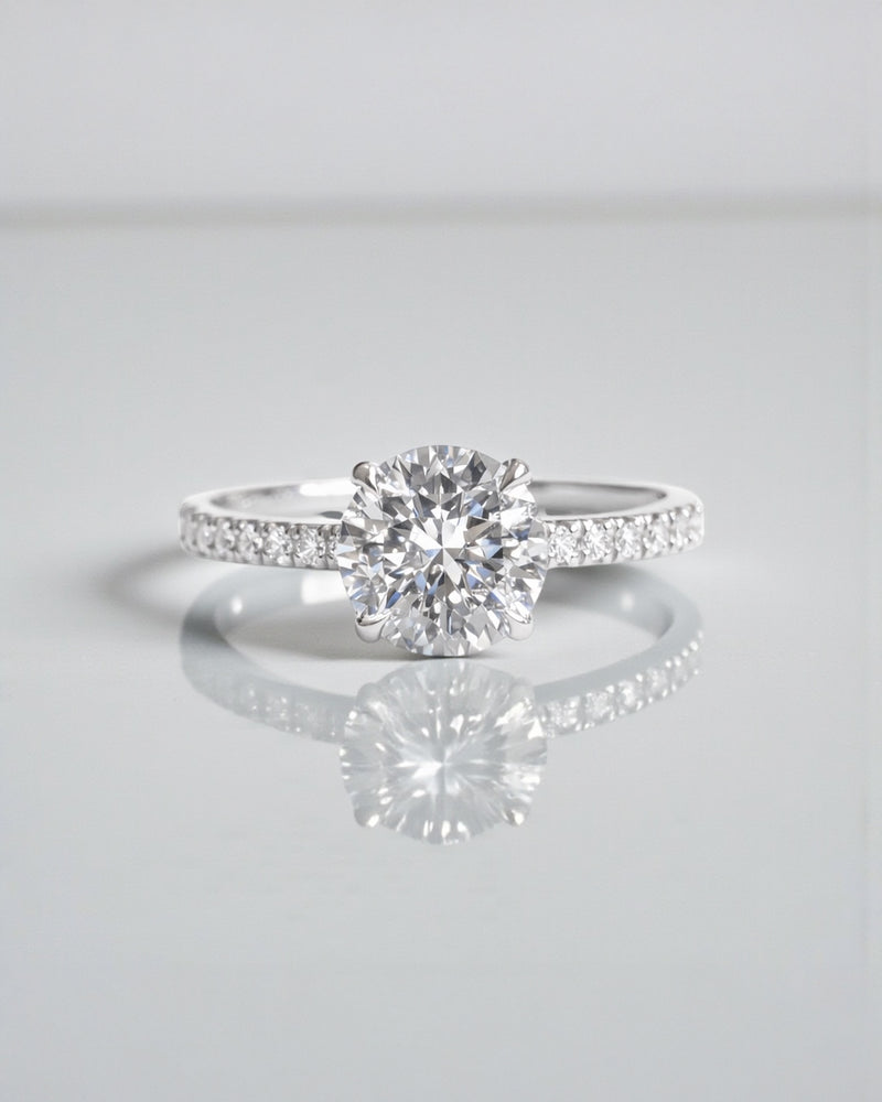 1ct round brilliant cut lab grown diamond engagement ring with diamond shoulder band and hidden halo