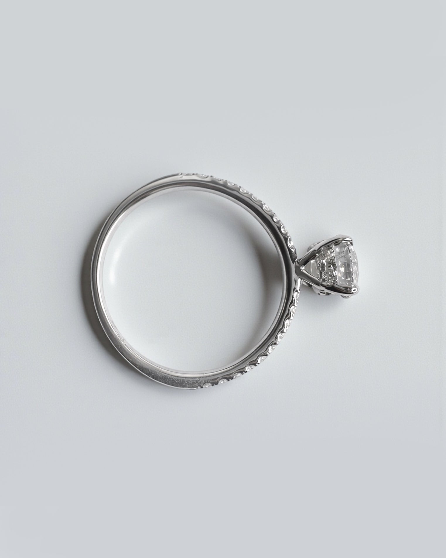 Round brilliant lab grown diamond ring with pavé diamond shoulders, luxury engagement ring
