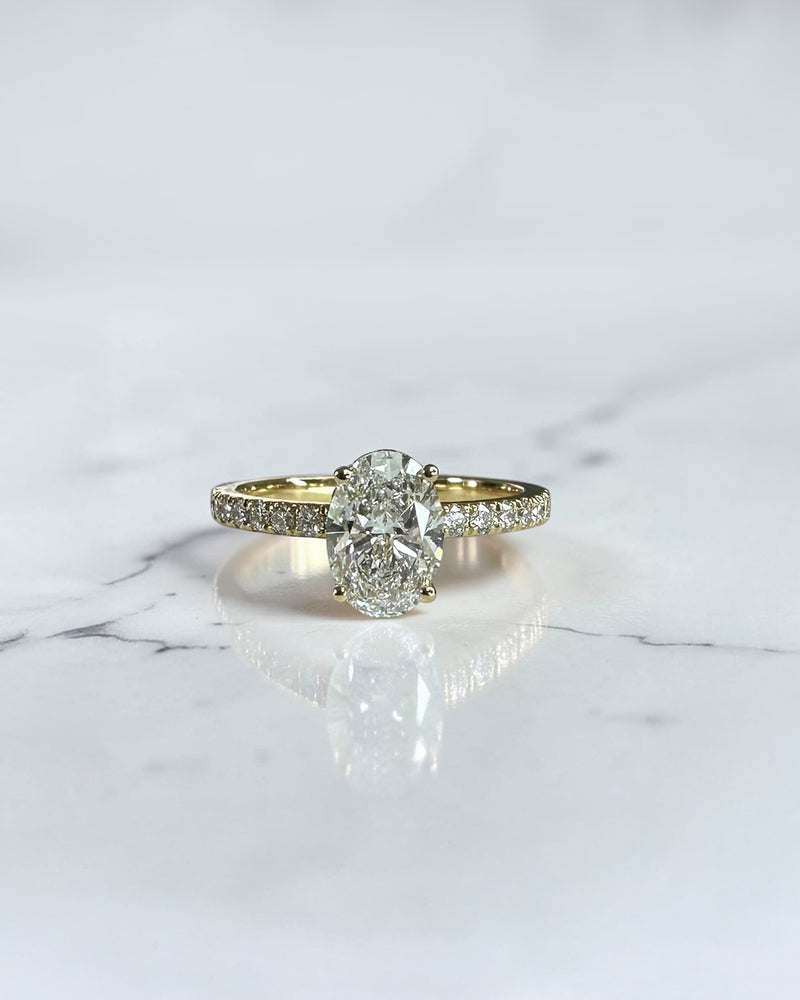 1ct oval cut lab grown diamond engagement ring with wrap around hidden halo and diamond shoulder band