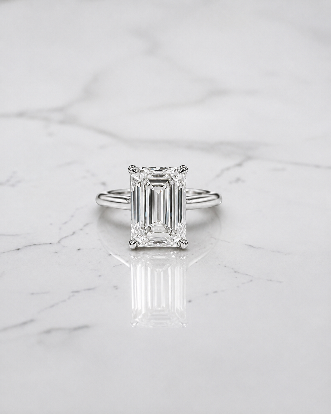 2.50ct emerald cut lab grown diamond cathedral engagement ring with diamond hidden halo, diamond bridge and polished band, handmade in London.