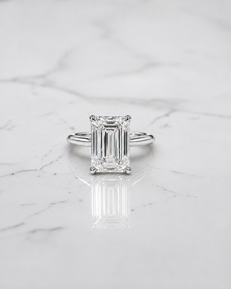 2.50ct emerald cut lab grown diamond cathedral engagement ring with diamond hidden halo, diamond bridge and polished band, handmade in London.
