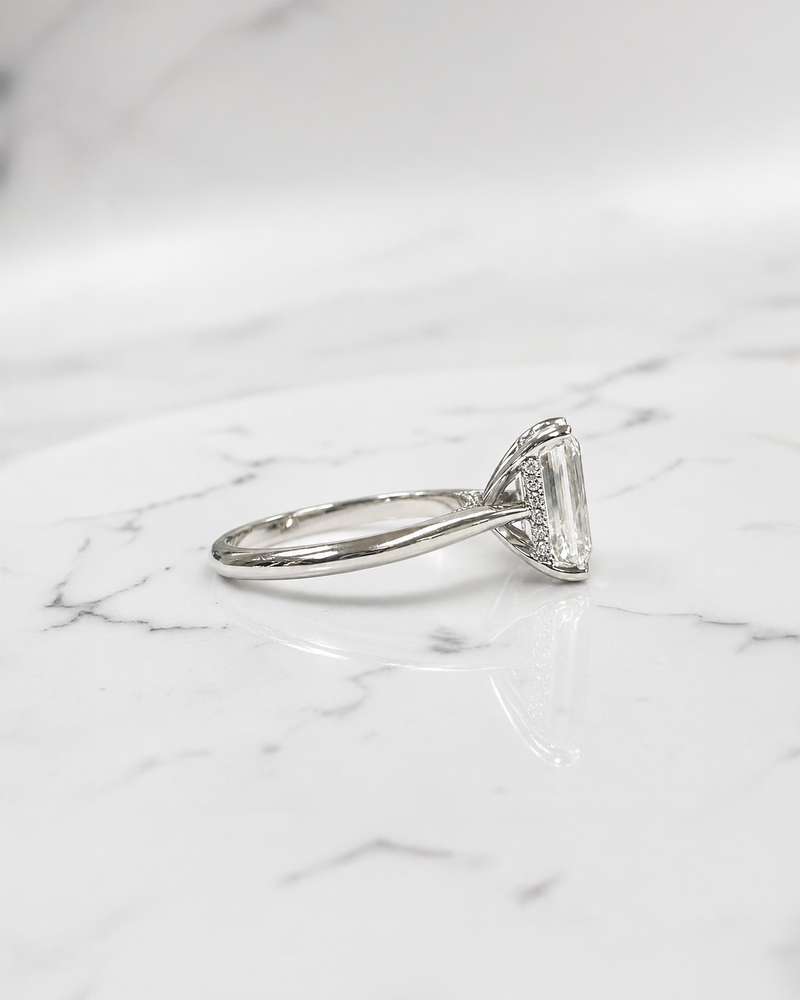 2.50ct emerald cut lab grown diamond cathedral engagement ring with diamond hidden halo, diamond bridge and polished band, handmade in London.