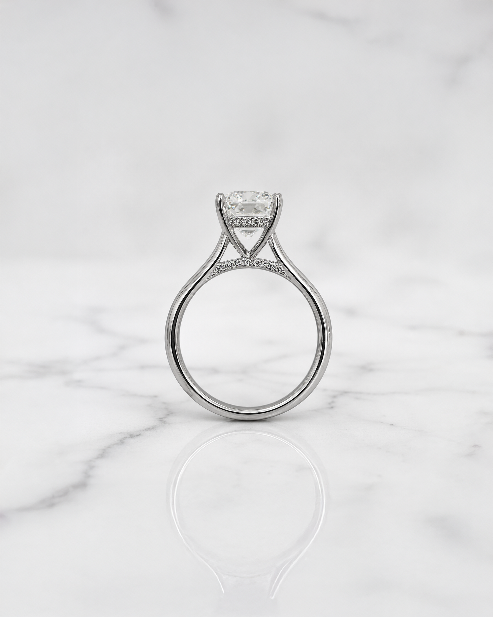 2.50ct emerald cut lab grown diamond cathedral engagement ring with diamond hidden halo, diamond bridge and polished band, handmade in London.