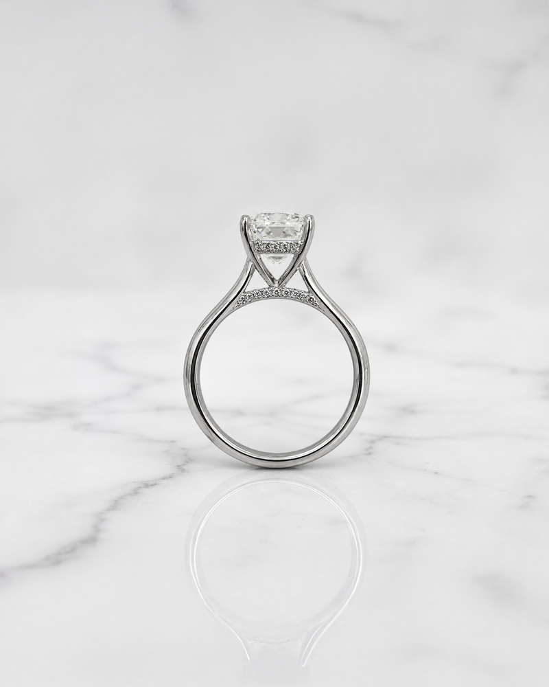 2.50ct emerald cut lab grown diamond cathedral engagement ring with diamond hidden halo, diamond bridge and polished band, handmade in London.