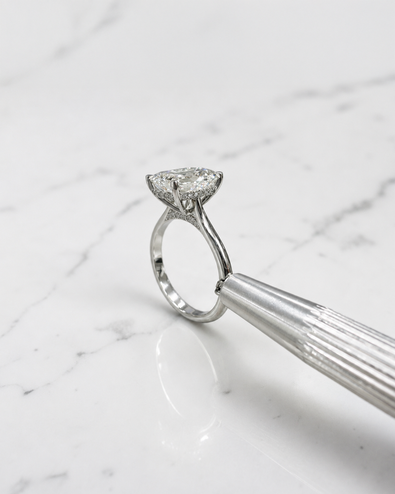 2.50ct emerald cut lab grown diamond cathedral engagement ring with diamond hidden halo, diamond bridge and polished band, handmade in London.