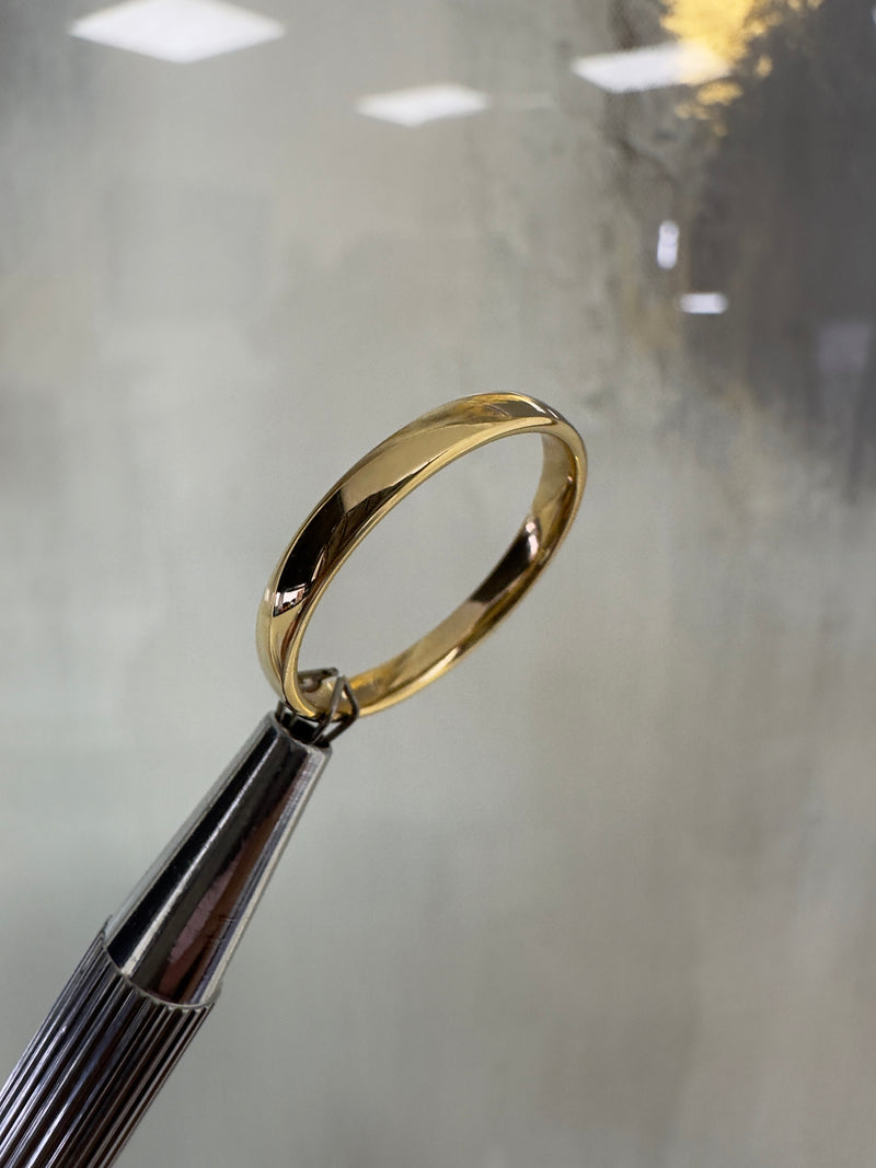2.5mm Court Wedding Band with a soft comfort fit profile in polished 18ct yellow gold, handcrafted in London.