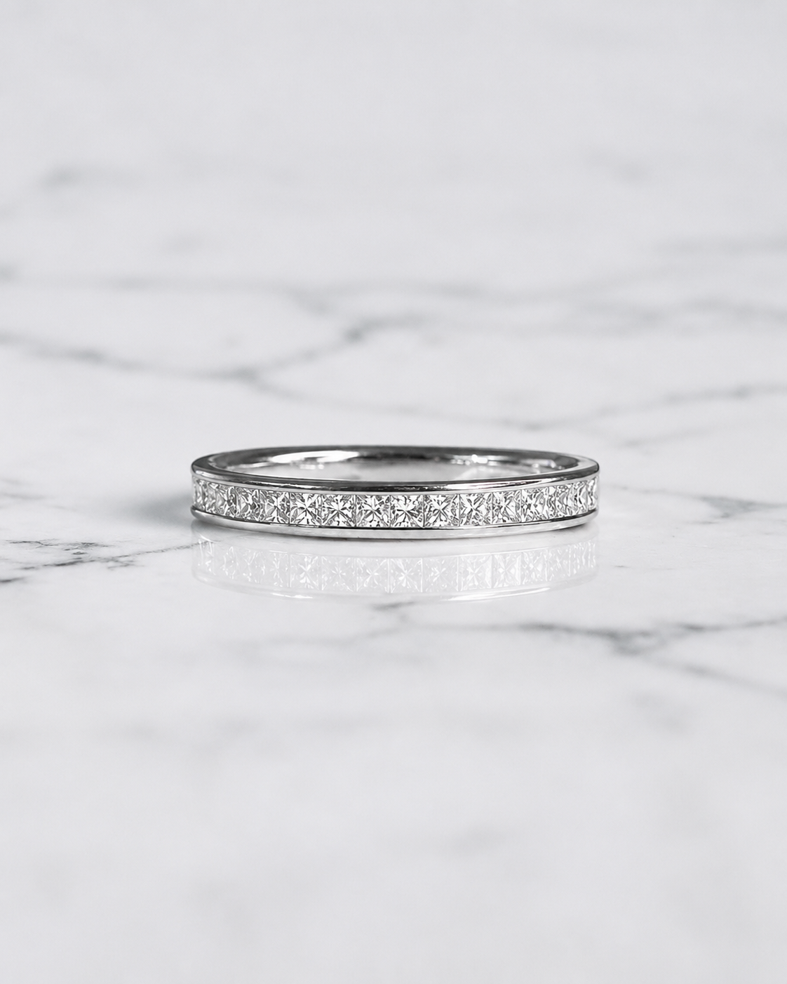 2.5mm princess cut diamond channel set wedding band with 0.40ct half set diamonds in polished white gold.